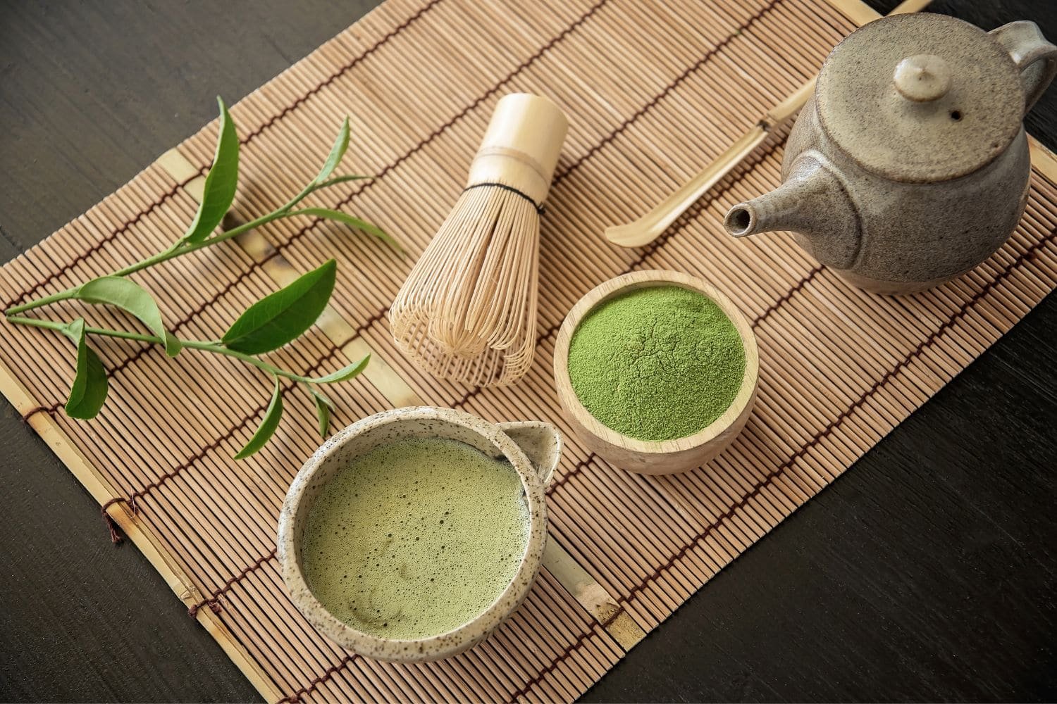 poudre et bol de matcha sur un set en bambou